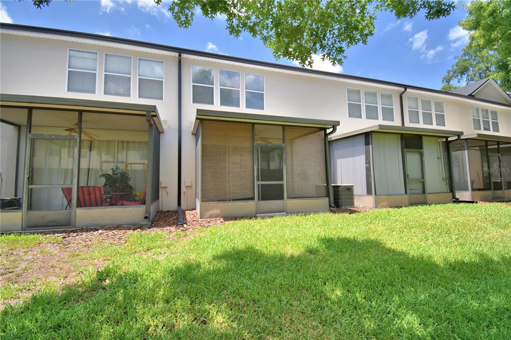 3151 Sinclair Street, Unit 104 Orlando, FL 32835 - Photo 52 of 64 a front view of a house with a yard and garage