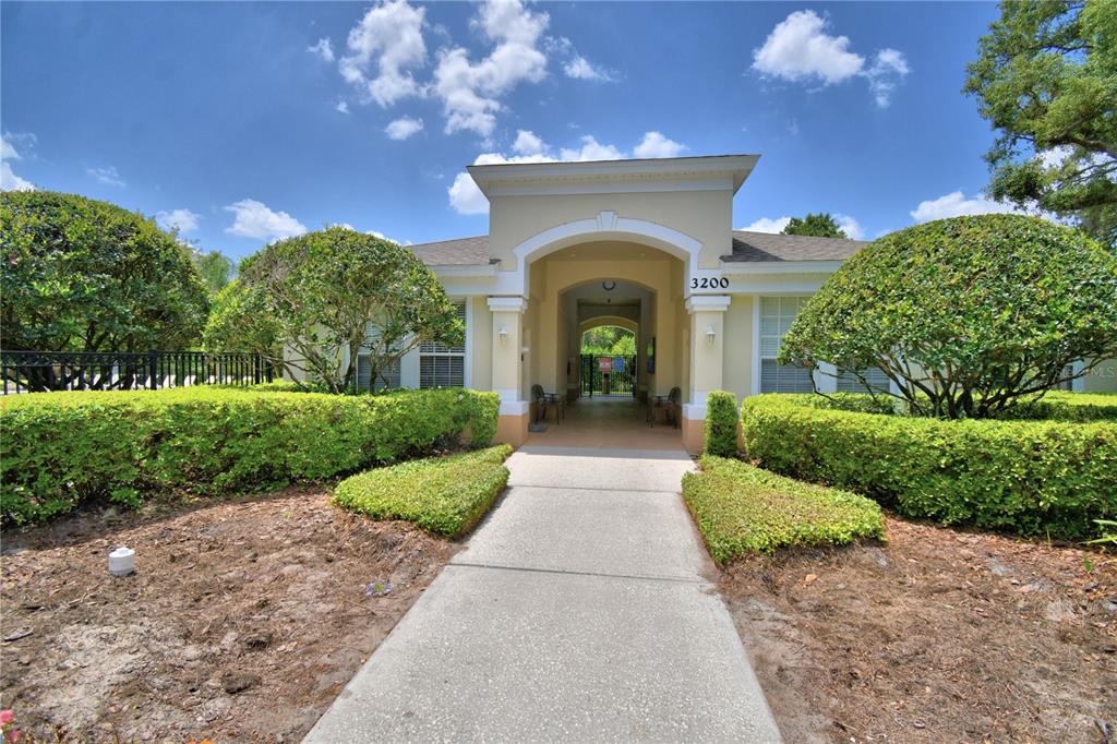 3151 Sinclair Street, Unit 104 Orlando, FL 32835 - Photo 57 of 64 a front view of a house with a yard