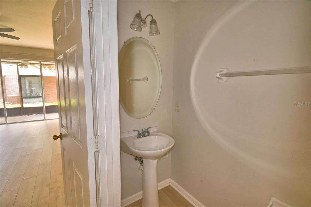 3151 Sinclair Street, Unit 104 Orlando, FL 32835 - Photo 7 of 64 a bathroom with a sink a mirror and a shower