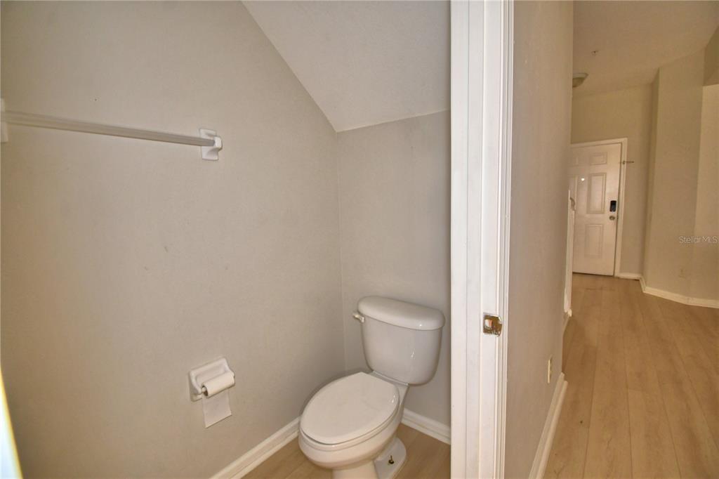 3151 Sinclair Street, Unit 104 Orlando, FL 32835 - Photo 8 of 64 a white toilet sitting next to a bathroom sink