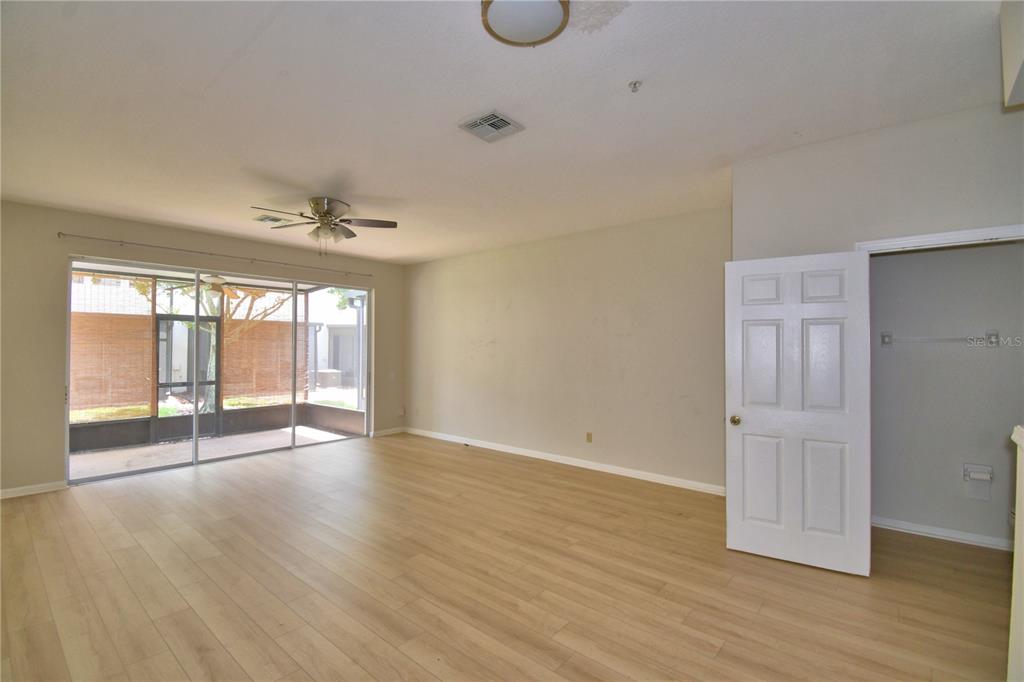 3151 Sinclair Street, Unit 104 Orlando, FL 32835 - Photo 10 of 64 an empty room with wooden floor and windows