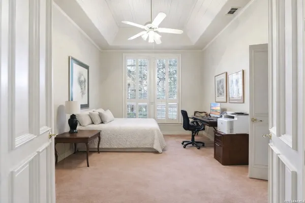 a bedroom with furniture and a window