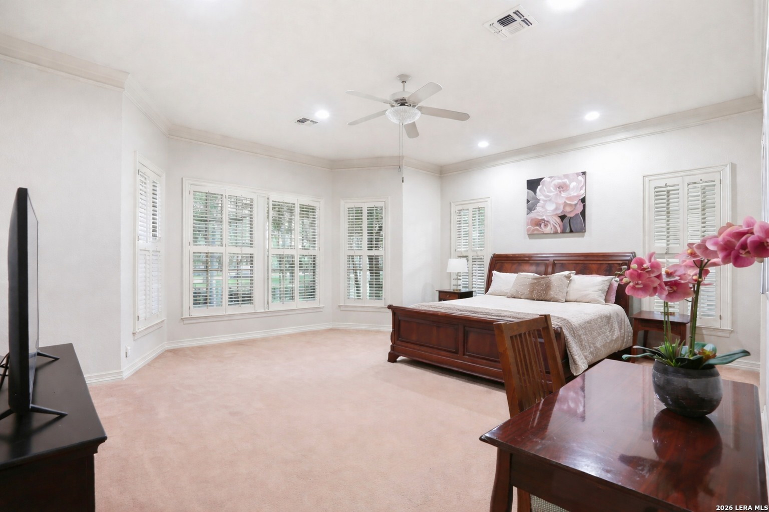 21759 Forest Waters Circle Garden Ridge, TX 78266 - Photo 16 of 30 a spacious bedroom with a bed and a flat screen tv