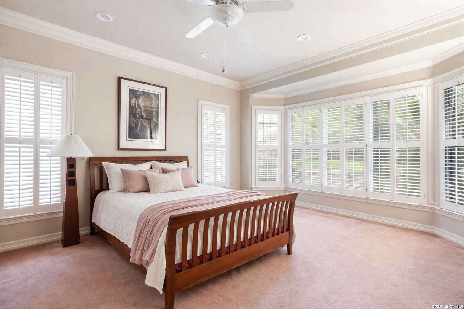 21759 Forest Waters Circle Garden Ridge, TX 78266 - Photo 19 of 30 a bedroom with a large bed and a chandelier