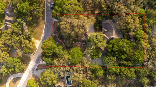 a backyard of a building with lots of trees