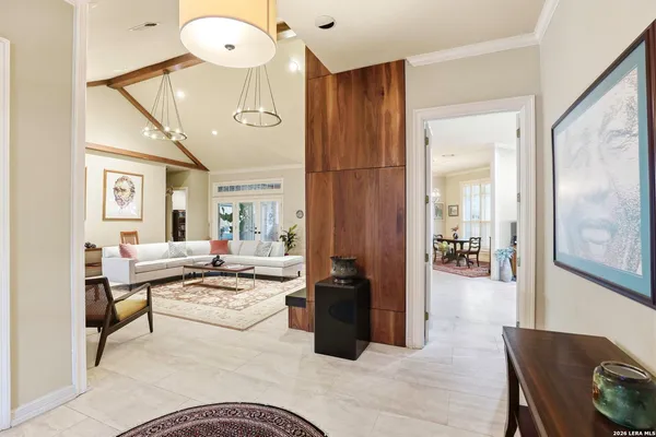 a living room with couches chairs and couches with wooden floor