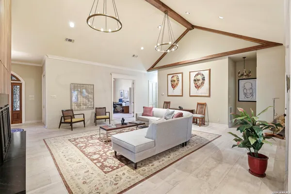 a living room with furniture and a potted plant