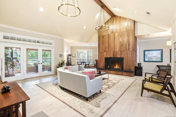 a living room with furniture fireplace and a table