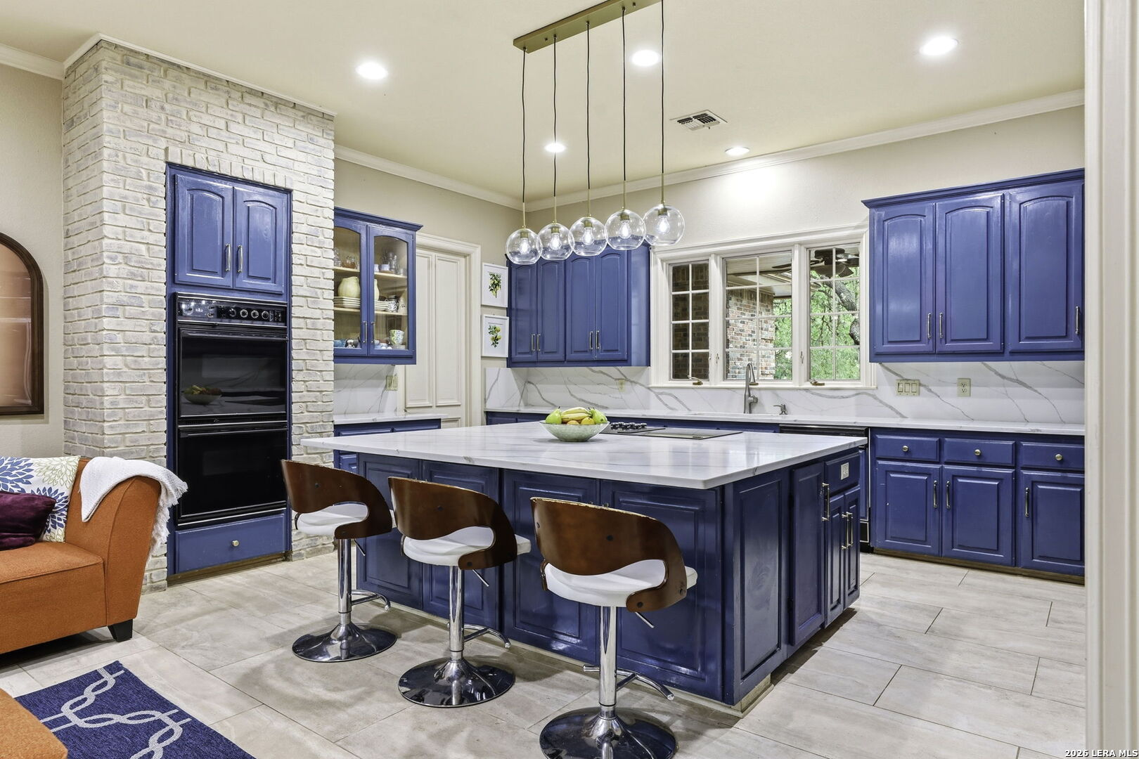 21759 Forest Waters Circle Garden Ridge, TX 78266 - Photo 10 of 30 a kitchen with granite countertop a table chairs stove a refrigerator and cabinets