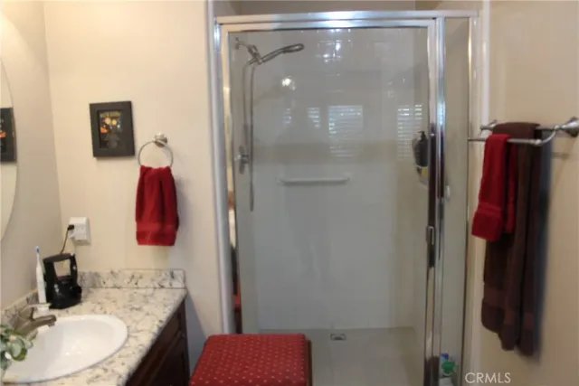 a bathroom with a granite countertop tub shower and sink