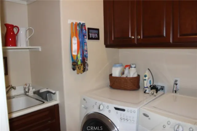 a room with a sink and a washer dryer