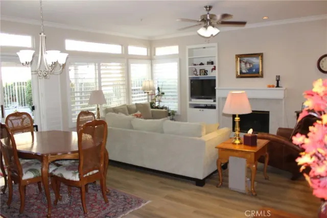 a living room with fireplace furniture and a large window