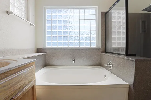 a bathroom with a bathtub and window