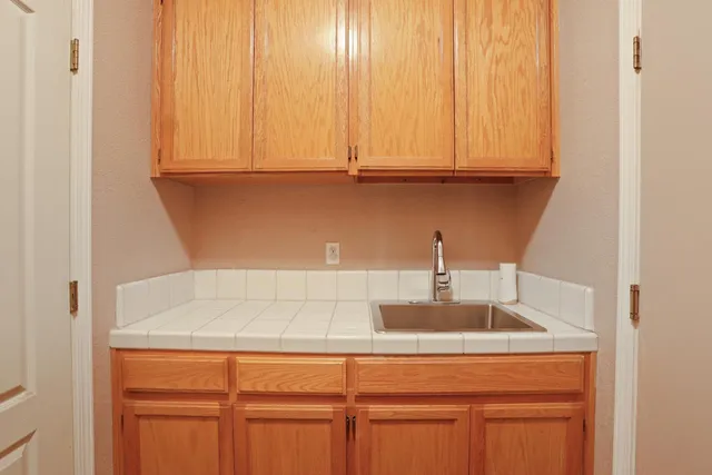 a kitchen with stainless steel appliances granite countertop white cabinets and a sink