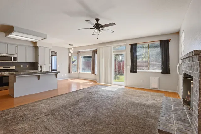 a view of an empty room with a kitchen