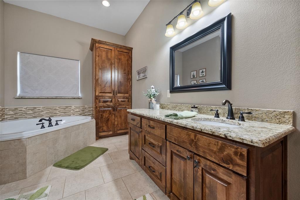 606 Sunset Point Kerens, TX 75144 - Photo 17 of 39 a bathroom with a tub sink and mirror