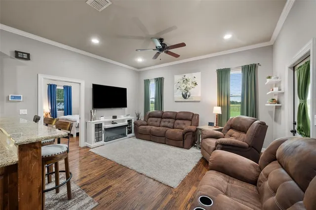 a living room with furniture and a flat screen tv