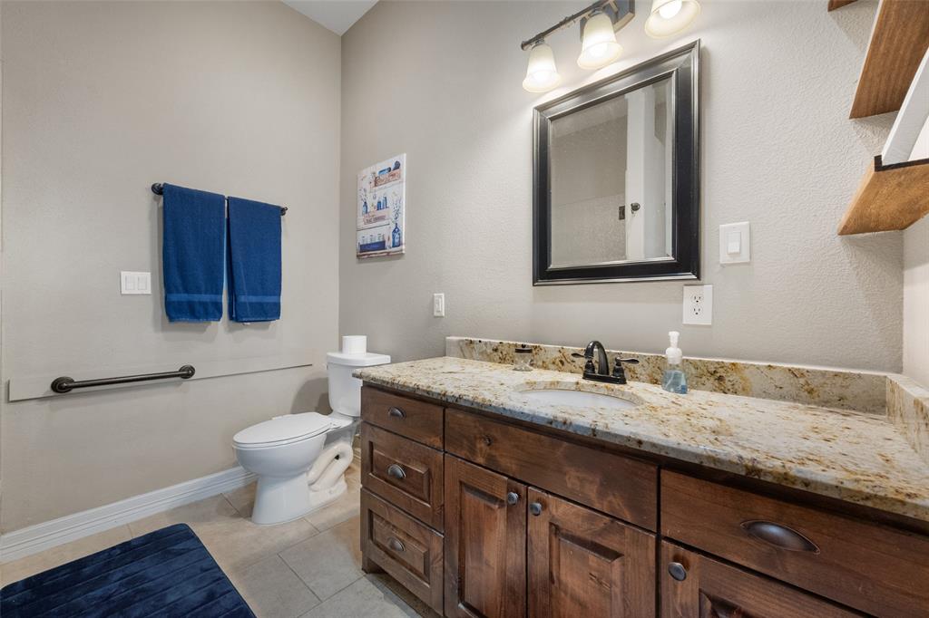 606 Sunset Point Kerens, TX 75144 - Photo 31 of 39 a bathroom with a granite countertop toilet sink and mirror