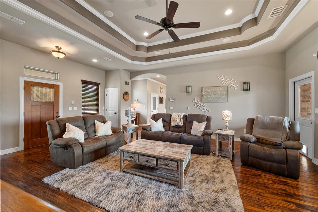 606 Sunset Point Kerens, TX 75144 - Photo 4 of 39 a living room with furniture wooden floor and a ceiling fan