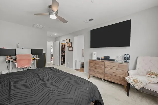 a bedroom with furniture and flat screen tv