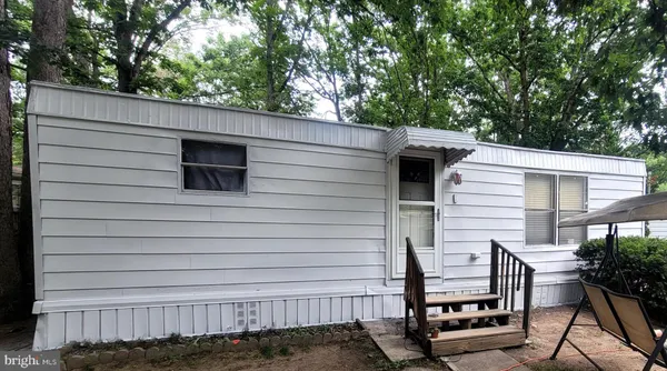 a side view of a house with a backyard