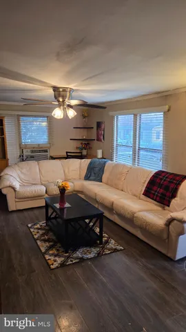 a living room with furniture a rug and a window