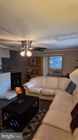 a living room with furniture a rug and a chandelier