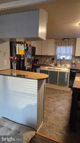 a large kitchen with stainless steel appliances granite countertop a sink counter space and cabinets