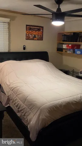 a bedroom with a bed and a television