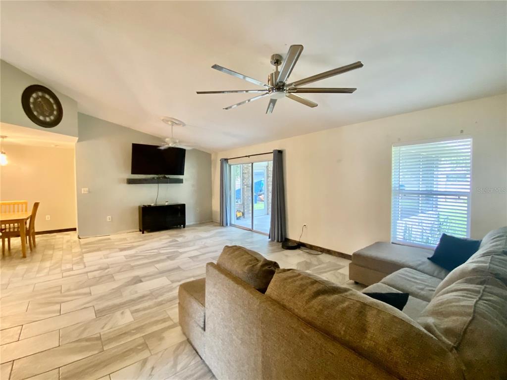7971 Waupegan Avenue Sebastian, FL 32958 - Photo 12 of 26 a living room with furniture and a flat screen tv