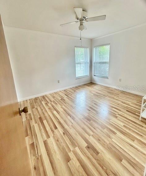 7971 Waupegan Avenue Sebastian, FL 32958 - Photo 19 of 26 an empty room with wooden floor fan and windows