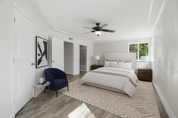 a bedroom with a bed and a chair