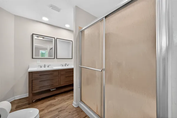 a bathroom with a sink mirror vanity and toilet
