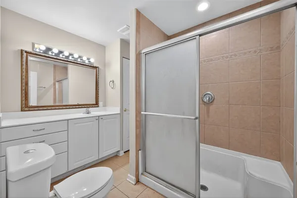 a bathroom with a toilet a sink and shower