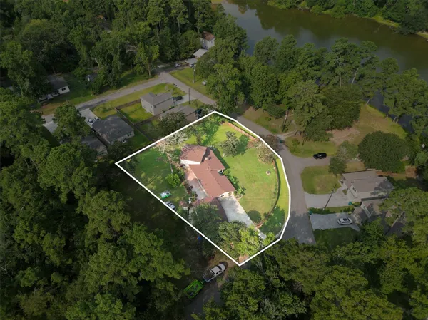 an aerial view of a house a yard and a swimming pool
