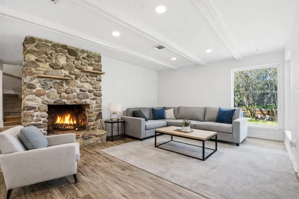 a living room with furniture and a fireplace