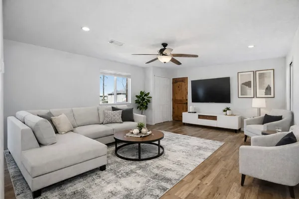 a living room with furniture and a flat screen tv
