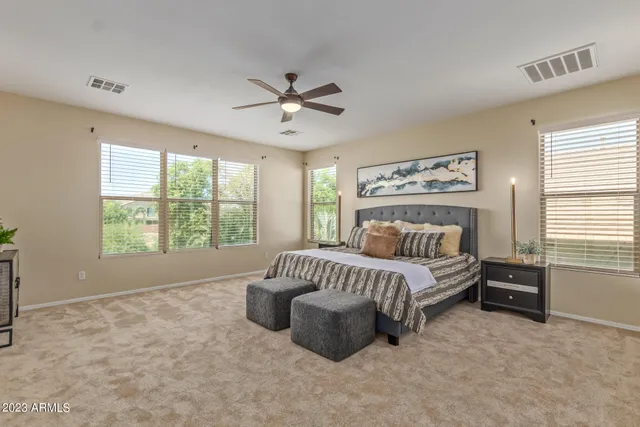 a spacious bedroom with a bed and a window