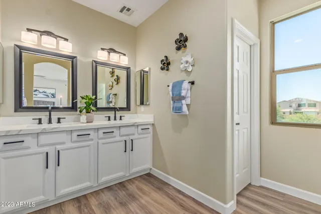 a spacious bathroom with a double vanity sink and a mirror