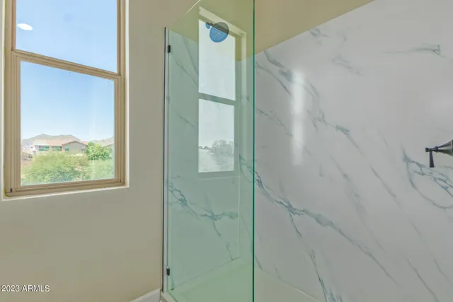 a bathroom with a shower and a glass door