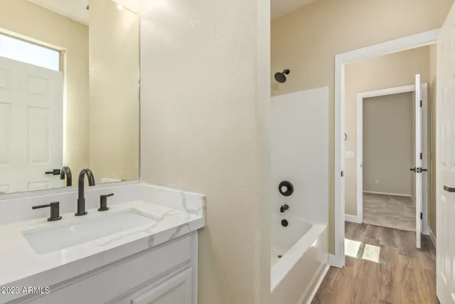 a bathroom with a sink a mirror and shower