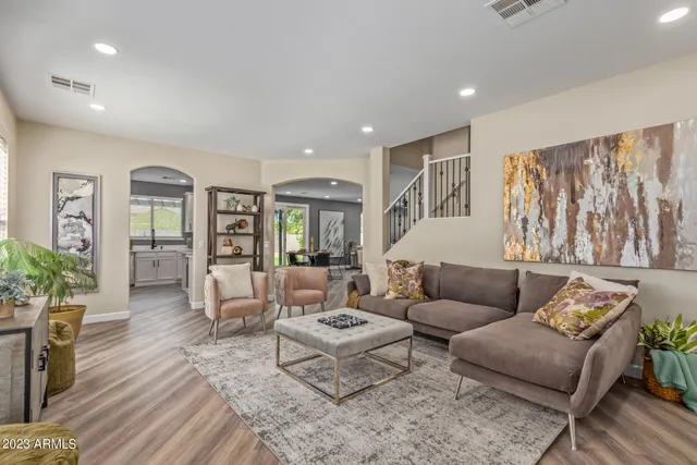 a living room with furniture and wooden floor