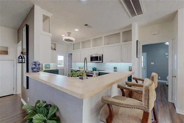 a kitchen with a table and chairs