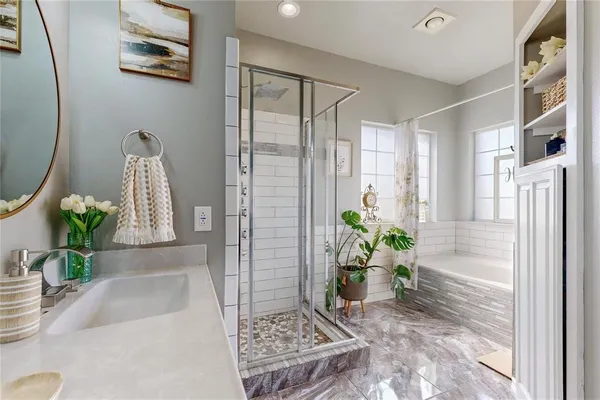 a view of a hallway with wooden floor and a potted plant