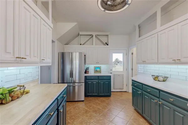 a kitchen with stainless steel appliances granite countertop a refrigerator and a stove