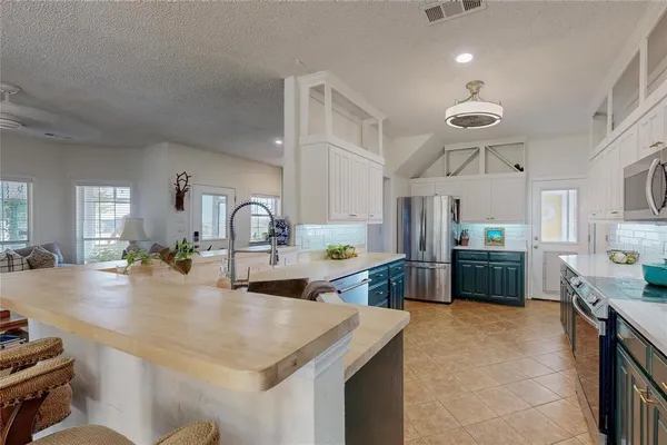 a kitchen with sink a stove and refrigerator