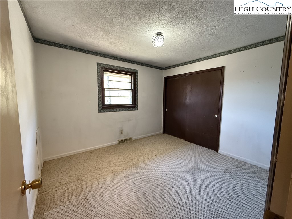 288 Sussex Road Grassy Creek, NC 28631 - Photo 11 of 22 an empty room with windows