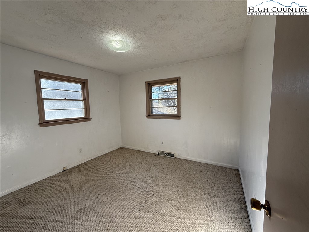 288 Sussex Road Grassy Creek, NC 28631 - Photo 12 of 22 an empty room with windows