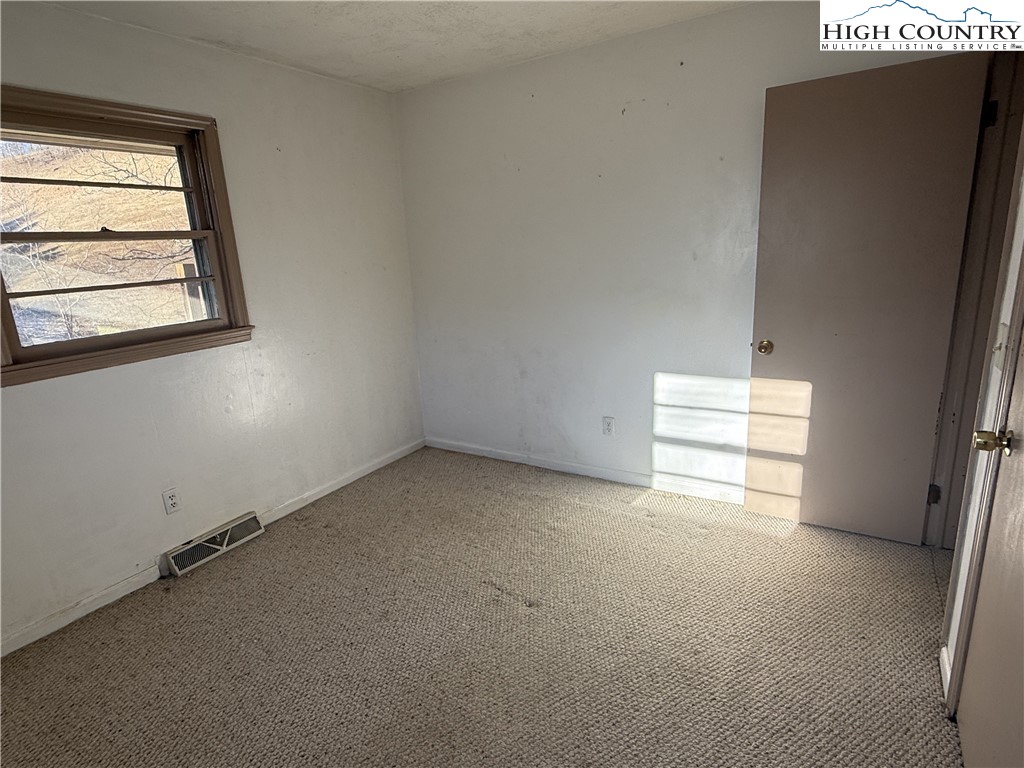 288 Sussex Road Grassy Creek, NC 28631 - Photo 13 of 22 an empty room with windows and closet