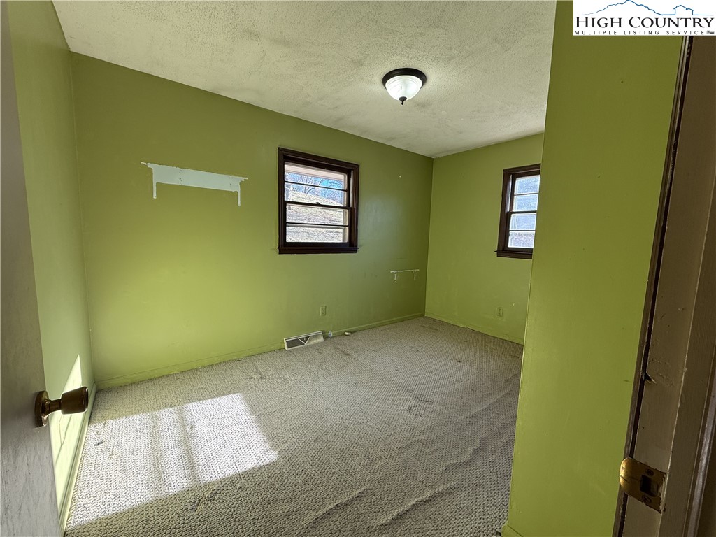 288 Sussex Road Grassy Creek, NC 28631 - Photo 14 of 22 a view of a room with a air conditioner and a window
